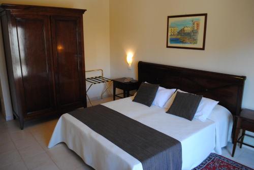 锡拉库扎Hotel Park Siracusa Sicily的一间卧室配有一张大床和一个橱柜