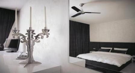 布拉迪斯拉发埃斯普利特酒店的一间卧室配有一张床和吊扇