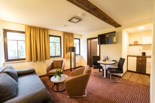 苏尔希尔施高登纳酒店的客厅配有沙发和桌子