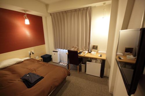 高松高松世纪酒店的配有一张床和一张书桌的酒店客房