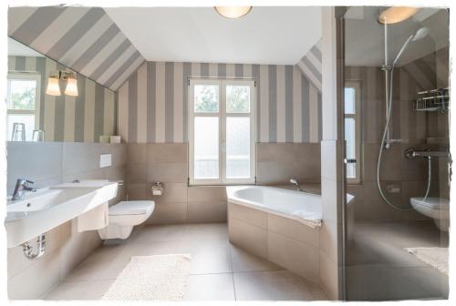 朗克维茨Ferienhaus Malve in Liepe的带浴缸、盥洗盆和卫生间的浴室