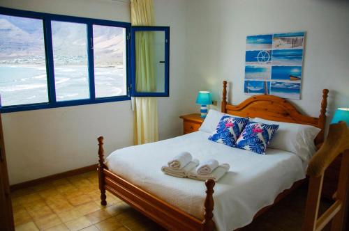 法马拉Seaview Risco de Famara 1的一间卧室配有一张床,并备有2个拖鞋