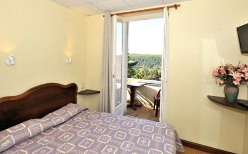 韦兹莱康波斯特拉酒店的一间卧室设有一张床和一个滑动玻璃门