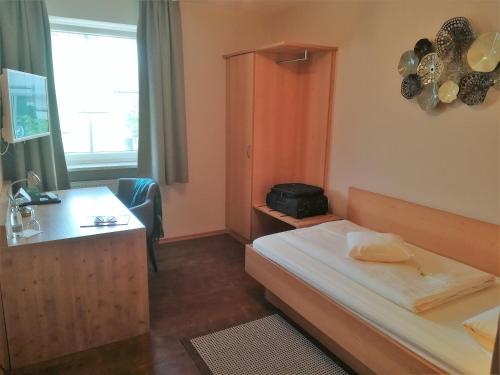 奥博斯提姆厄灵格兰德酒店的配有一张床和一张书桌的酒店客房