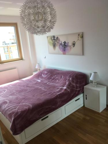 萨格勒布Korkyra的一间卧室配有一张带紫色毯子的床