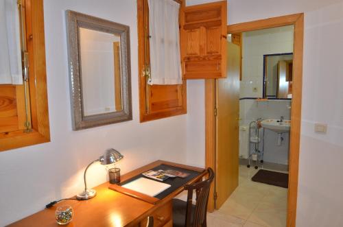 格拉纳达斯尔丽酒店的客房设有书桌和带水槽的浴室。