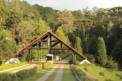 坎波斯杜若尔当Hotel Recanto São Cristóvão - Próximo ao Parque Tarundu的一座树木繁茂的公园里的道路上的桥梁