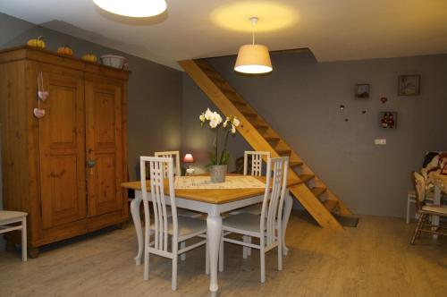 坎特赞Au Coeur d'Alsace Chambres d'hôtes的一间带桌椅和楼梯的用餐室