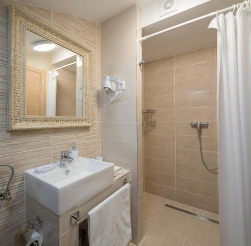奥米什Villa Charlotte的浴室配有盥洗盆和带镜子的淋浴