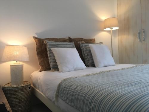 特罗亚Soltroia Beachouse的一间卧室配有一张带枕头的床和两盏灯。