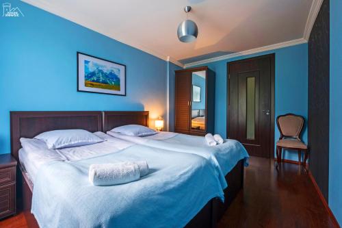 BechoBecho House的一间卧室配有一张带蓝色墙壁的大床