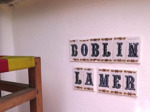 大巴萨姆Boblin la Mer hotel restaurant plage的墙上的标志,上面写着“bostonianeianeaiden”字样