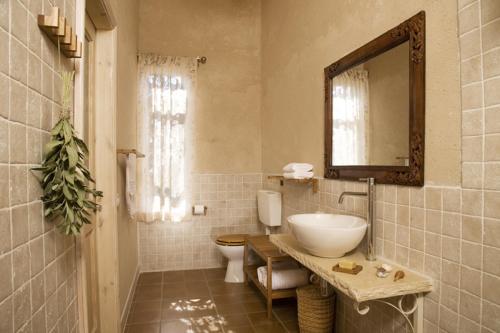 兹奇隆亚科夫萨玛达-旅馆的一间带水槽、卫生间和镜子的浴室