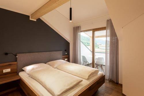阿皮亚诺苏拉斯特拉达Mederle Hof的一间卧室设有一张床和一个大窗户