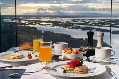 普诺GHL Hotel Lago Titicaca的餐桌上摆放着早餐食品和果汁