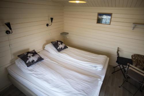教堂城艾富力维克度假屋的一间卧室配有两张带白色床单和枕头的床。
