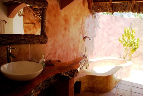 基济姆卡济Karamba Eco Boutique Hotel的浴室配有盥洗盆和浴缸。