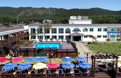 泰安马里博酒店的酒店设有一个游泳池和带遮阳伞的桌子。