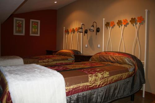 Ampudia拉斯卡西塔斯德帕佩尔酒店的墙上花房的两张床