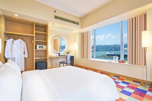 香港悦品海景酒店(观塘)的一间卧室设有一张大床和一个大窗户