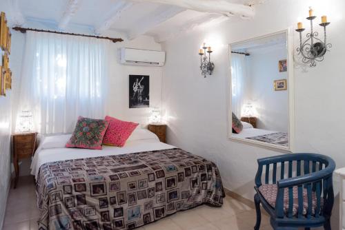 圣安东尼奥派伊维萨岛酒店的一间卧室配有一张床、镜子和椅子