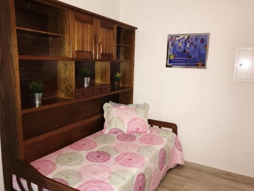 珀彻斯Dalia's House的一间卧室配有一张带木制床头板的床