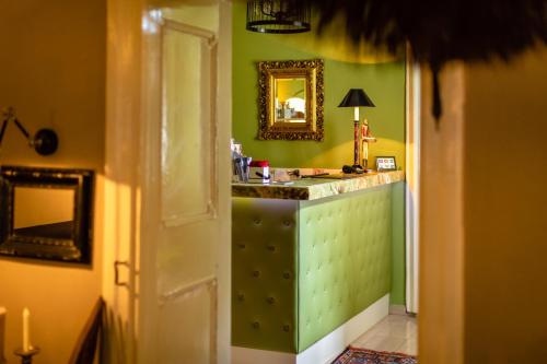 哈特贝格Boutique-Hotel Alter Gerichtshof的浴室设有绿色的墙壁和带镜子的梳妆台。