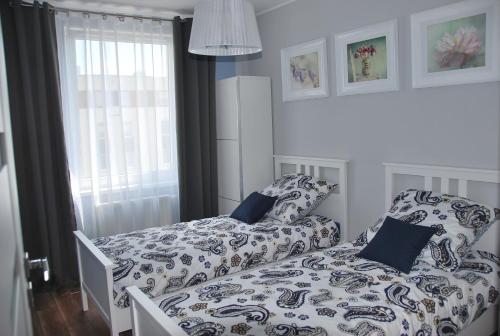 克拉科夫Margaret Apartments的卧室内的一张带被子和枕头的床