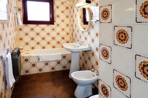 塞奥-德乌赫尔Duc Allotjament的浴室配有盥洗盆、卫生间和浴缸。