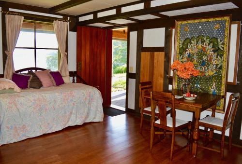 吉布森斯Oceanfront Suite的一间卧室配有一张床、一张桌子和一张桌椅