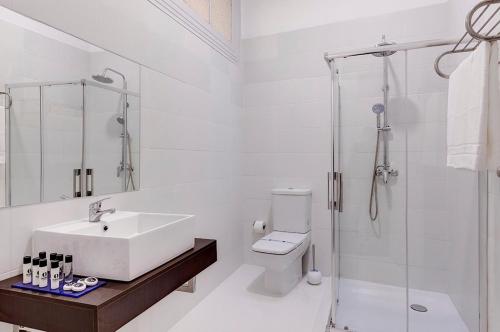欧瓦Ovar Apartments的白色的浴室设有水槽和淋浴。