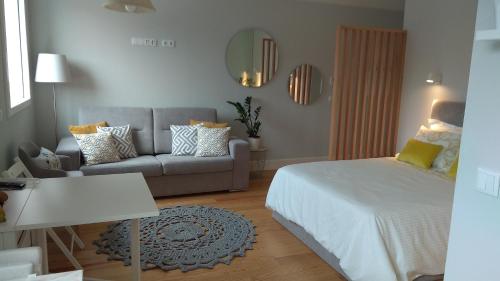 波尔图S Bento Boutique Apartment的客厅配有床和沙发