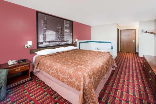 Paris速8巴黎酒店的酒店客房设有一张大床和红色的墙壁。