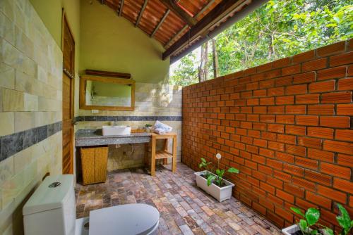 富国Azura Resort的一间带卫生间和砖墙的浴室