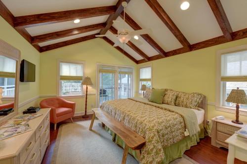 圣西蒙斯岛The Grey Owl Inn的一间卧室配有一张床、一把椅子和窗户。