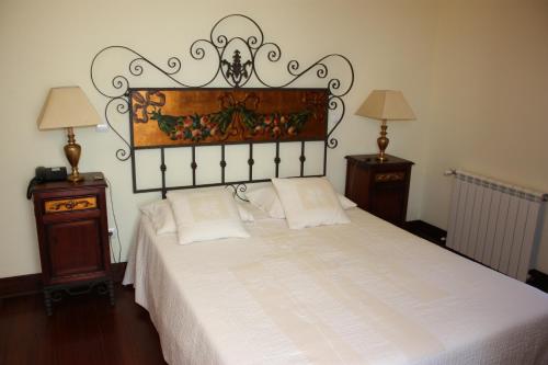 Freixinho卡尔穆夫人修道院酒店的卧室配有一张白色的床和大型床头板