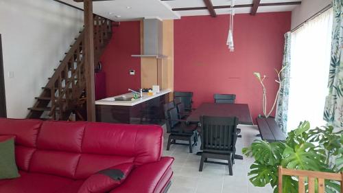 龙乡町Sol e Mar的客厅配有红色的沙发和桌子