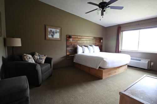 BakerHidden Canyon Retreat的卧室配有床、椅子和窗户。