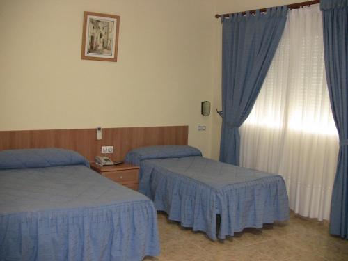 洛斯赫马纳斯酒店 客房内的一张或多张床位