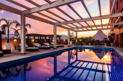 瓜达拉哈拉Barcelo Guadalajara的一个带凉棚的游泳池和一个度假村
