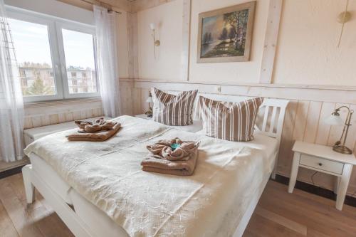 奥茨塞巴德·迪尔哈根Penthouse Meerblick的卧室配有白色床和毛巾