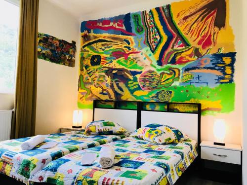 克瓦雷利Green House的一间卧室设有两张床,墙上挂着一幅画