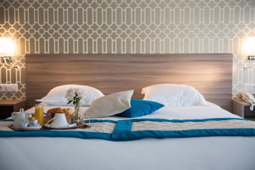拉里歇尔Hotel & Spa Radiana的一张带桌子的床,上面有早餐