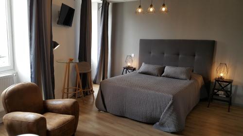 Neuville-sur-Ain奥珐萨昂德瑞酒店的一间卧室配有一张床和一把椅子