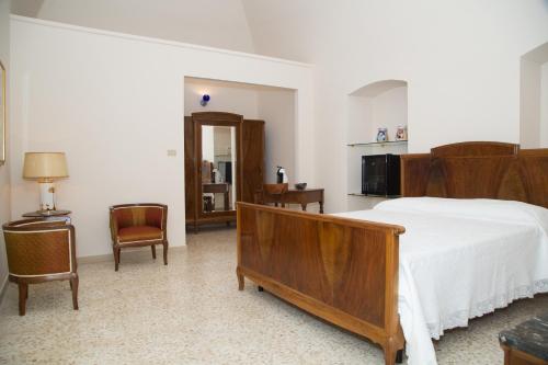 泰尔利齐Casa Catalano的一间卧室配有一张大型木制床和椅子