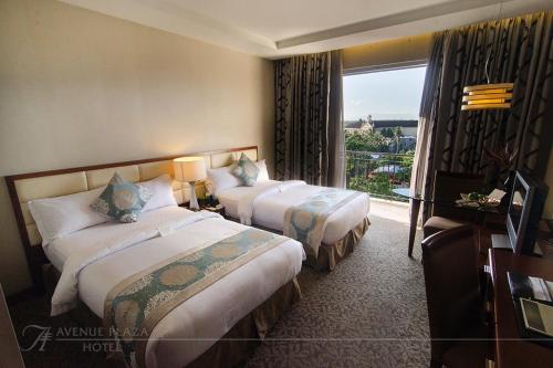 那牙广场大道酒店的酒店客房设有两张床和窗户。