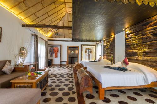 暹粒Bong Thom Forest Lodge的酒店客房,设有三张床和一张沙发