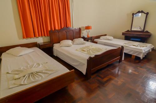 Hotel Indaiá客房内的一张或多张床位