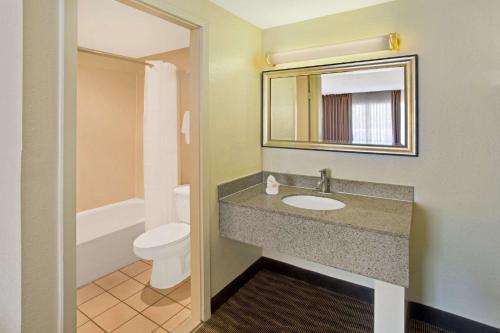 银泉银泉戴斯酒店的一间带水槽、卫生间和镜子的浴室