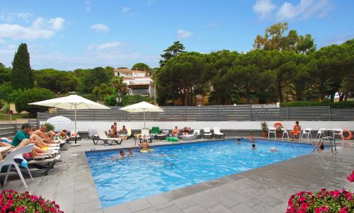 卡里拉夏日酒店的一群人坐在游泳池周围